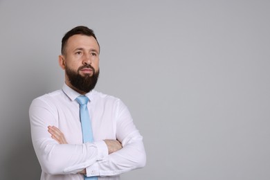 Photo of Handsome bearded man in formal outfit on grey background. Space for text