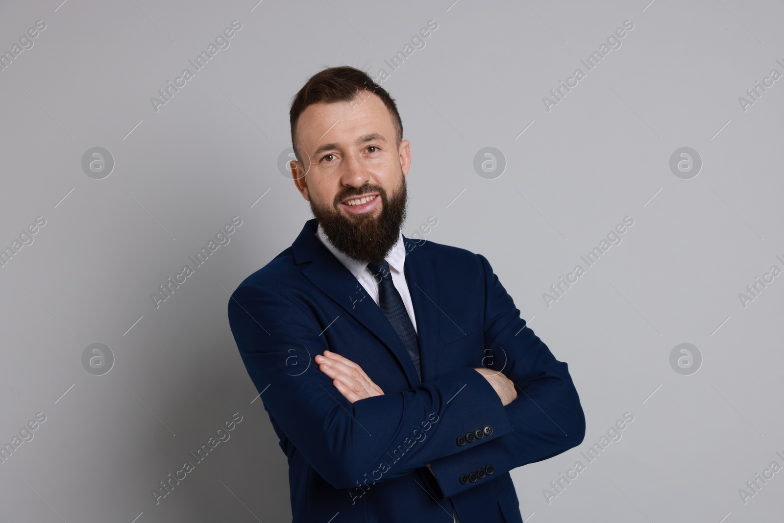 Photo of Handsome bearded man in suit on grey background