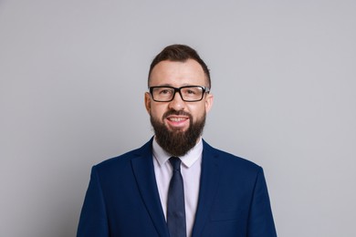 Handsome bearded man in suit on grey background