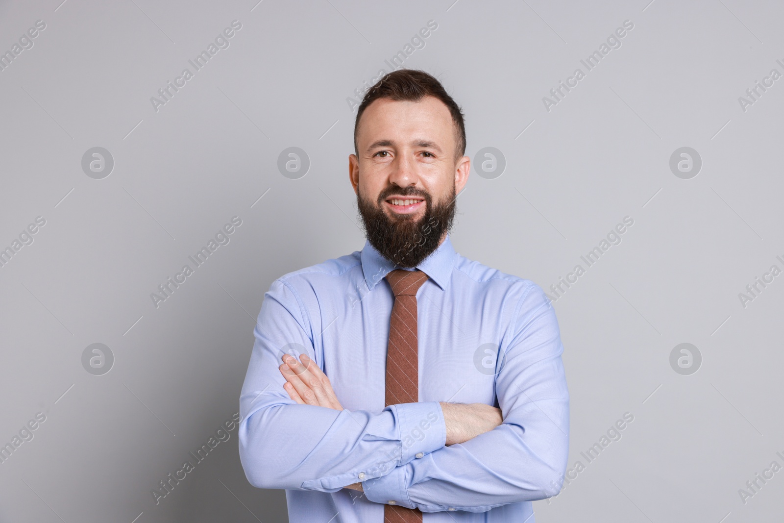 Photo of Handsome bearded man in formal outfit on grey background