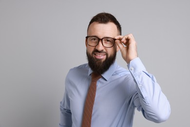 Photo of Handsome bearded man in formal outfit on grey background