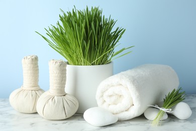 Photo of Spa composition with wheatgrass on white marble table