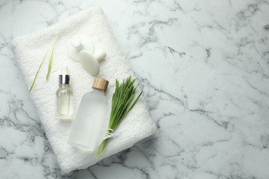 Photo of Spa composition with wheatgrass on white marble background, top view. Space for text