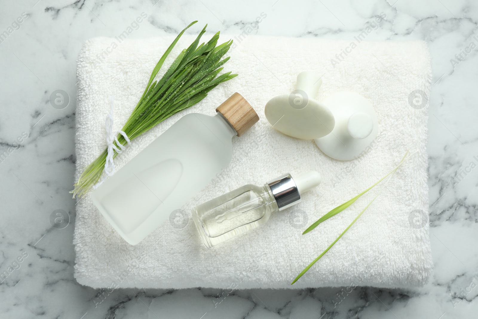 Photo of Spa composition with wheatgrass on white marble background, top view