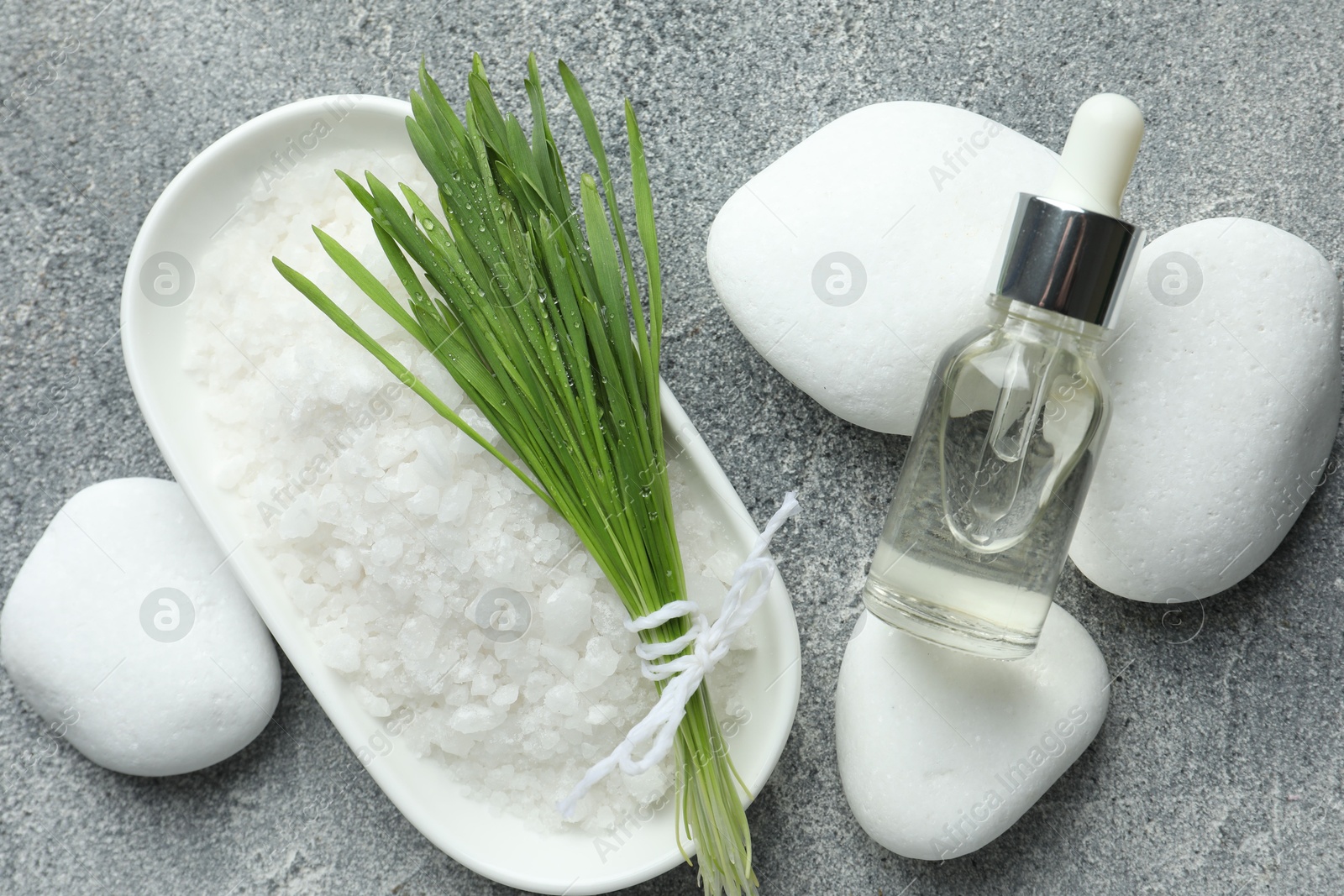 Photo of Spa composition with wheatgrass on grey background, flat lay