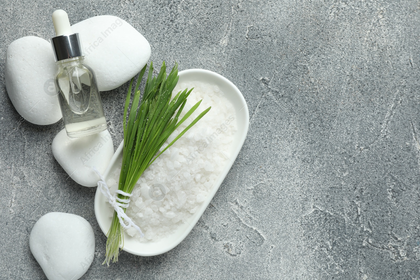 Photo of Spa composition with wheatgrass on grey background, flat lay. Space for text