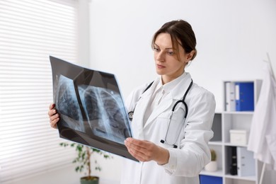 Doctor examining x-ray of lungs in hospital