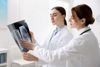 Photo of Doctors examining x-ray of lungs in hospital