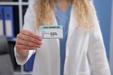 Receptionist giving medical insurance card in clinic, closeup