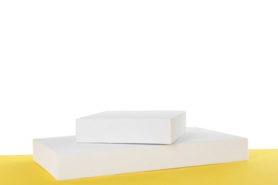 Podiums on yellow surface against white background. Presentation of product