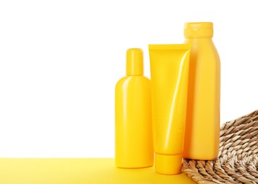 Photo of Different sun protection products on yellow surface against white background