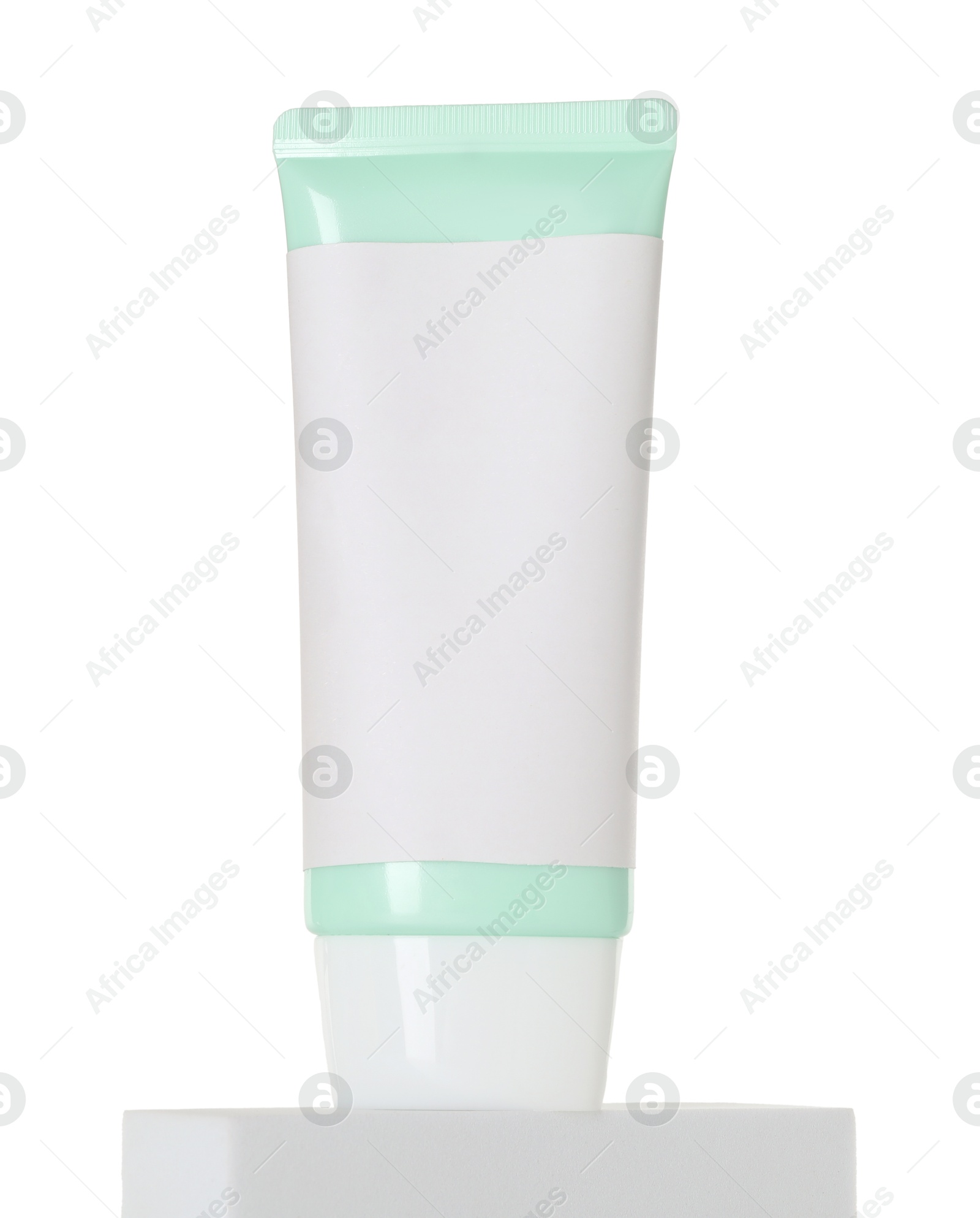 Photo of Tube of sun protection product on podium against white background