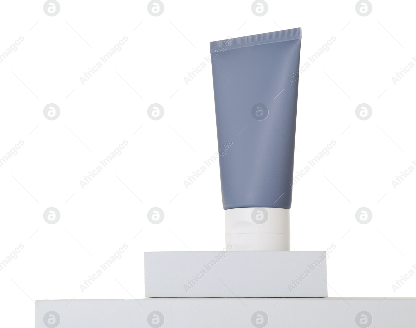 Photo of Tube of sun protection product on podium against white background