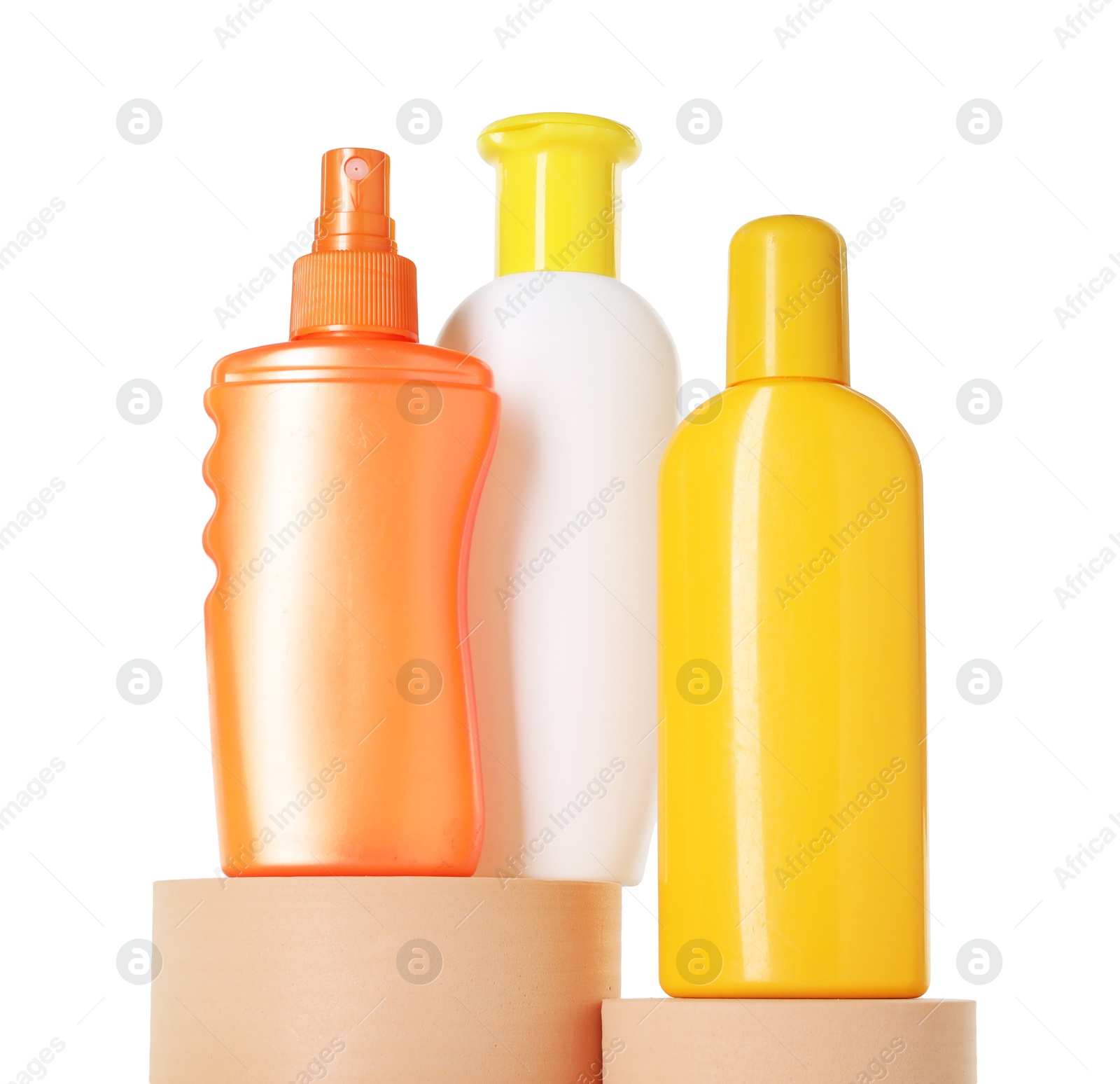 Photo of Different sun protection products on podiums against white background