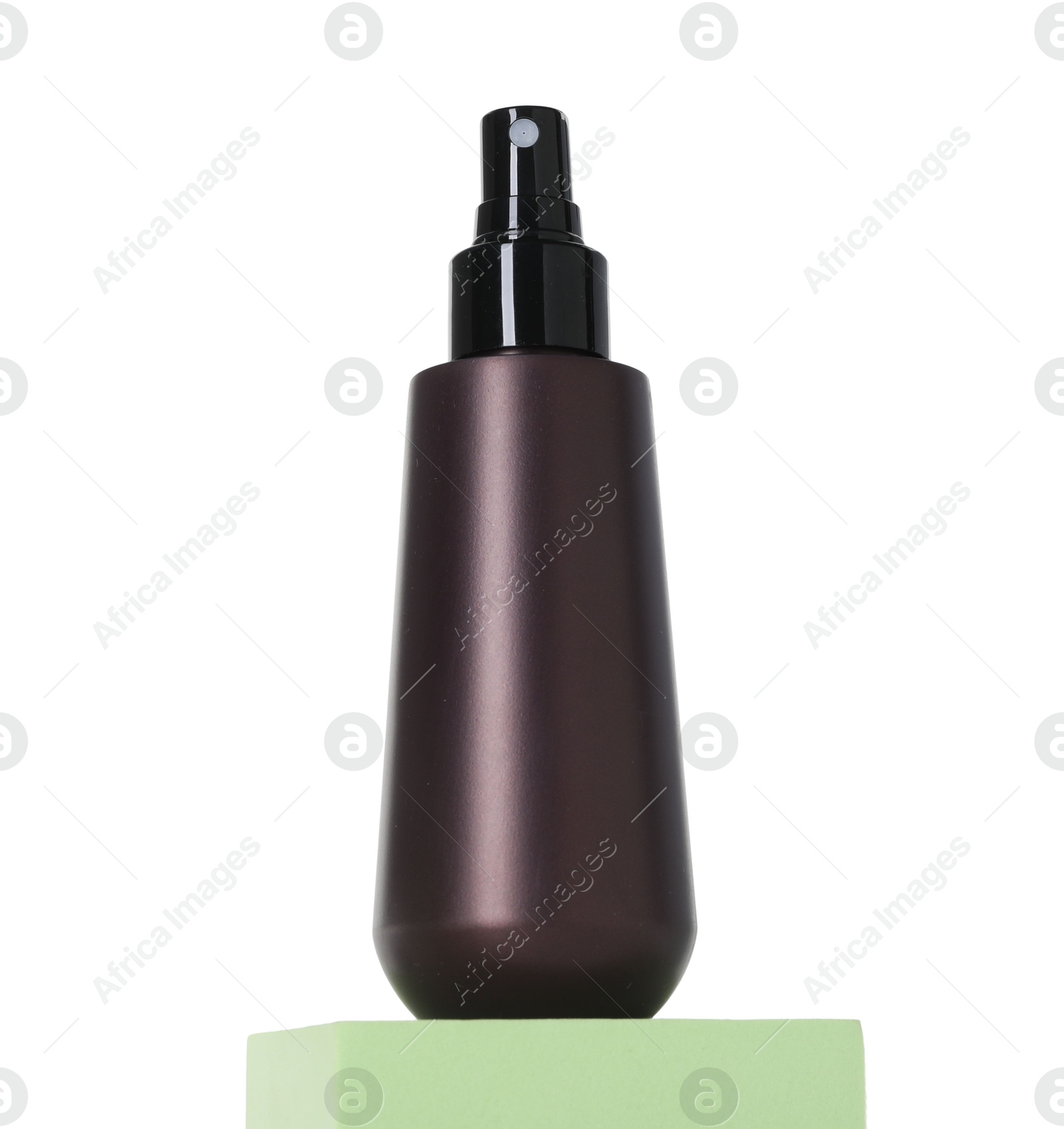 Photo of Bottle of sun protection product on podium against white background