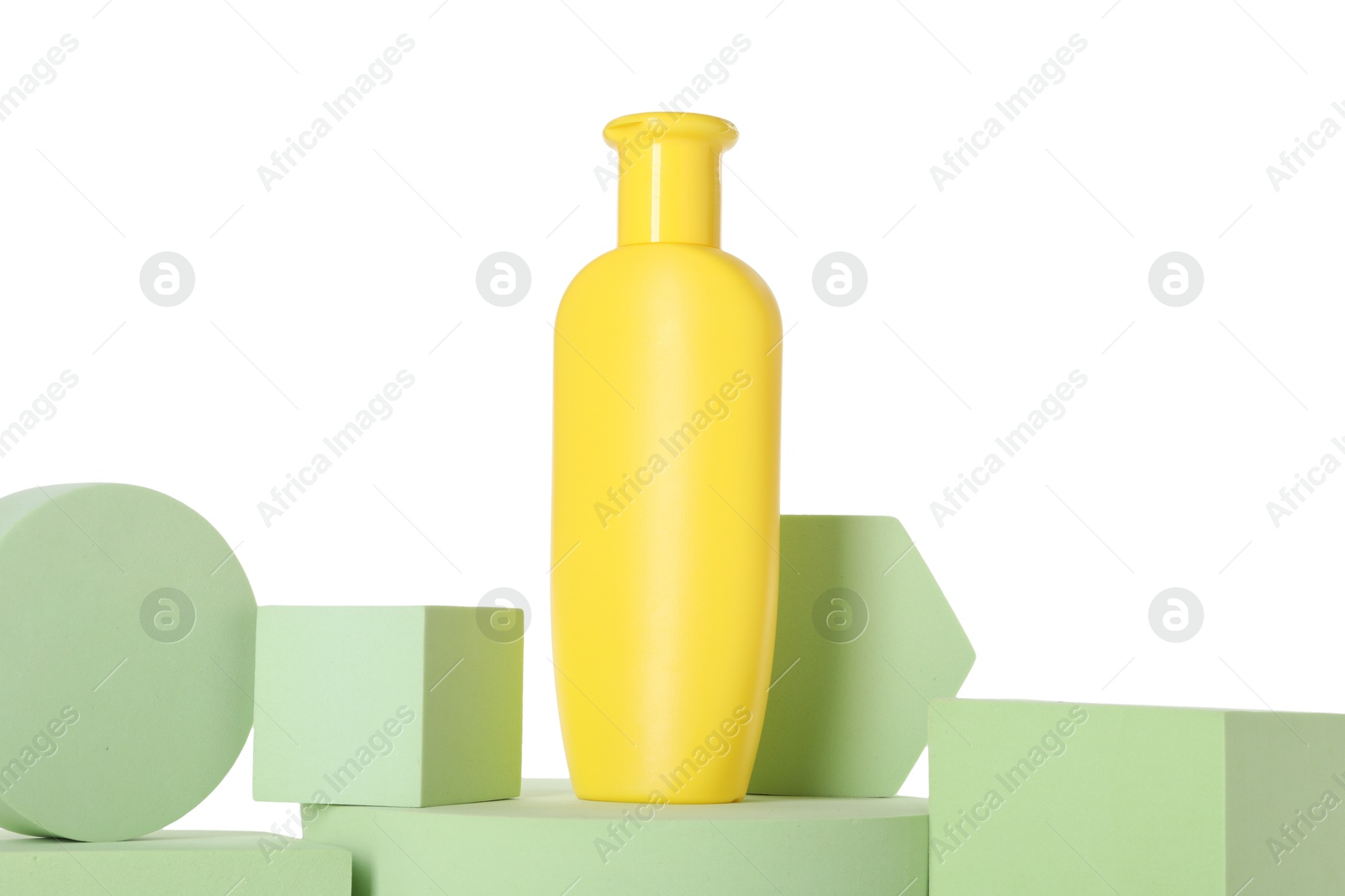 Photo of Bottle of sun protection product and podiums against white background