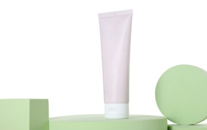 Tube of sun protection product and podiums against white background