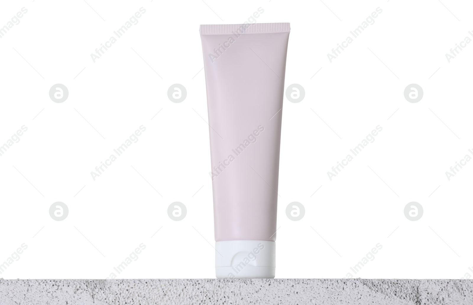 Photo of Tube of sun protection product on concrete surface against white background