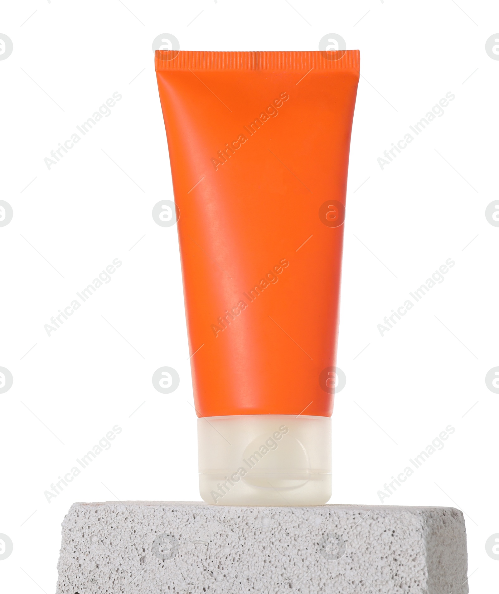 Photo of Tube of sun protection product on concrete block against white background