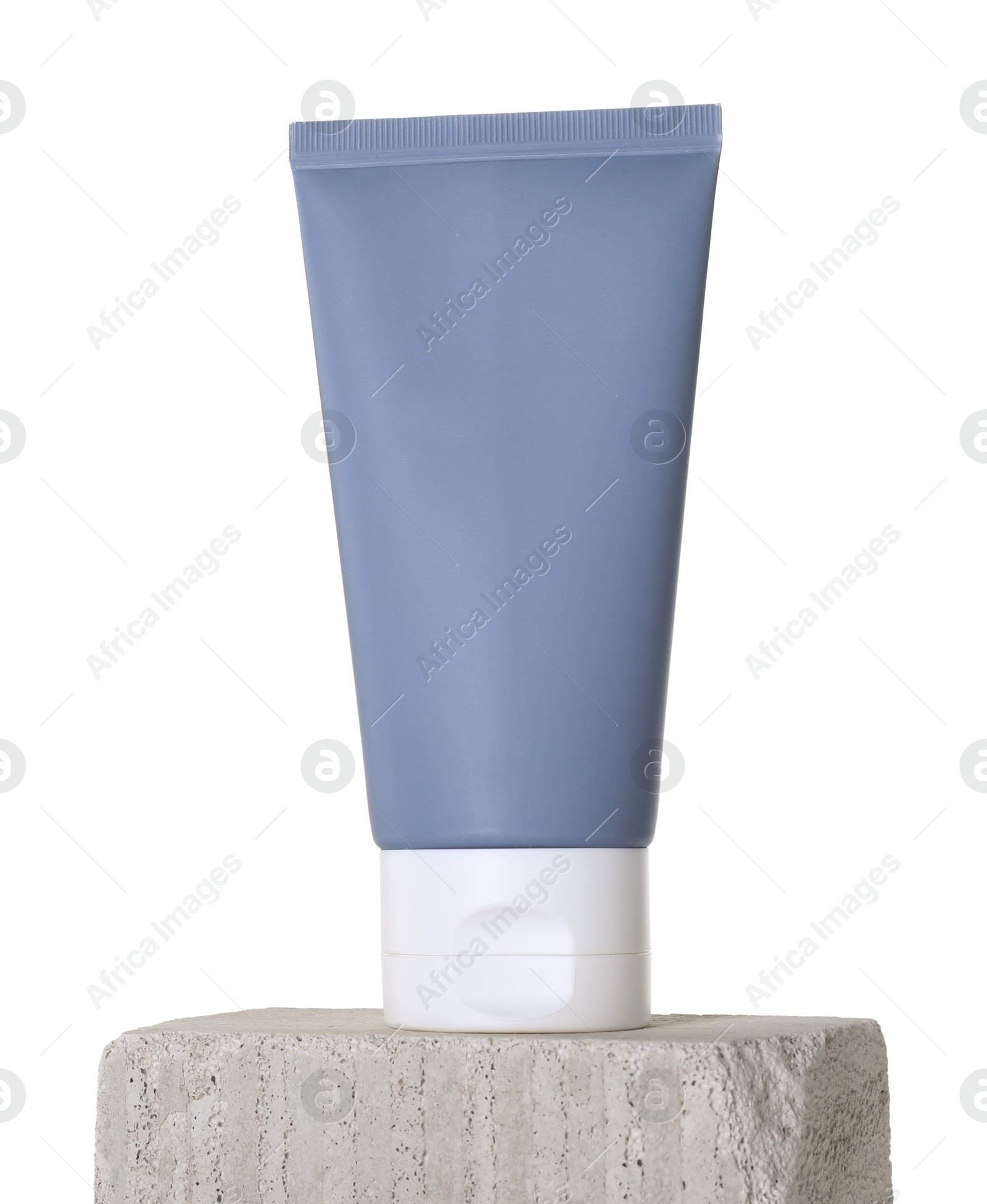 Photo of Tube of sun protection product on concrete block against white background