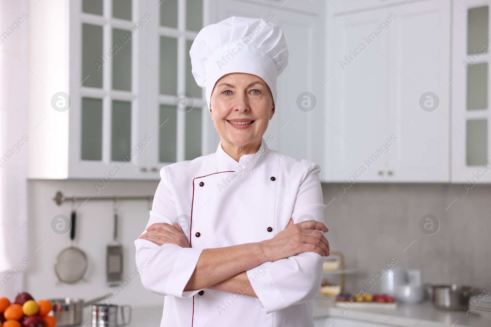 Photo of Professional pastry chef wearing uniform in kitchen