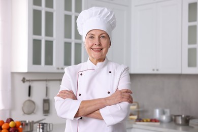 Professional pastry chef wearing uniform in kitchen