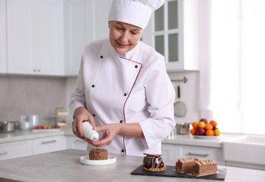 Photo of Professional pastry chef making dessert at table in kitchen