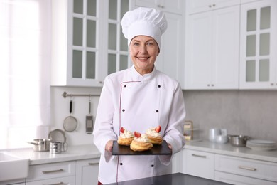 Photo of Professional pastry chef with desserts in kitchen