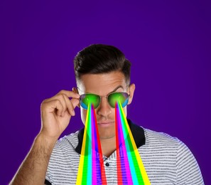 Fashionable man shooting with rainbow lasers out of his eyes through sunglasses on indigo color background, creative collage. Stylish poster