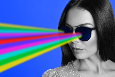 Image of Fashionable woman with rainbow lasers coming out of her sunglasses on blue background, creative collage. Stylish poster