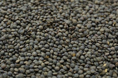 Photo of Raw green lentils as background, closeup view