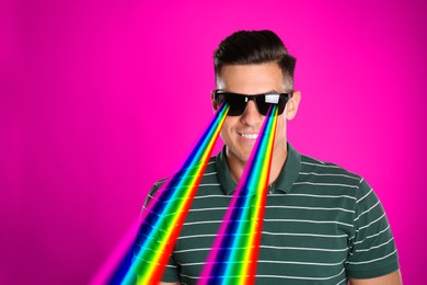 Image of Fashionable man with rainbow lasers coming out of his sunglasses on dark pink background, creative collage. Stylish poster