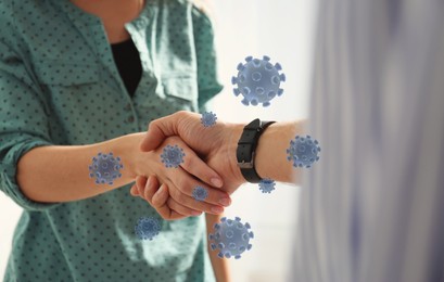 Image of Woman and man shaking hands, closeup. Illustration of viruses near handshake. Personal hygiene