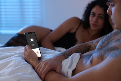 Image of Betrayal. Man getting phone call from his wife while he spending time with mistress on bed, closeup