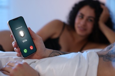 Image of Betrayal. Man getting phone call from his wife while he spending time with mistress on bed, closeup