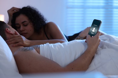 Image of Betrayal. Man getting phone call from his wife while he spending time with mistress on bed, closeup