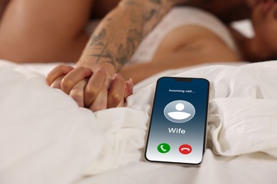 Image of Betrayal. Wife calling her husband on phone, while he spending time with mistress on bed, selective focus