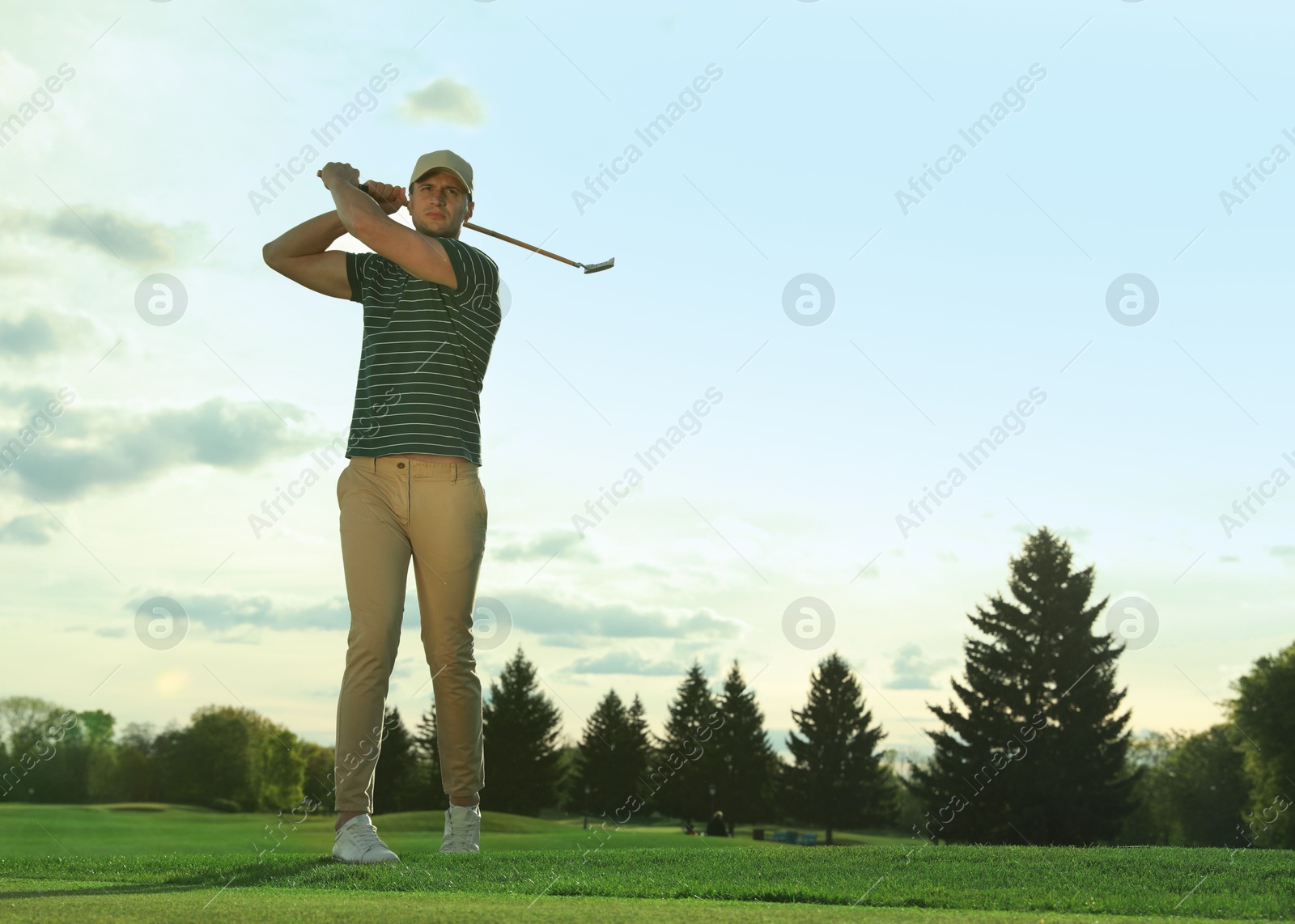 Photo of Man playing golf on green course, space for text