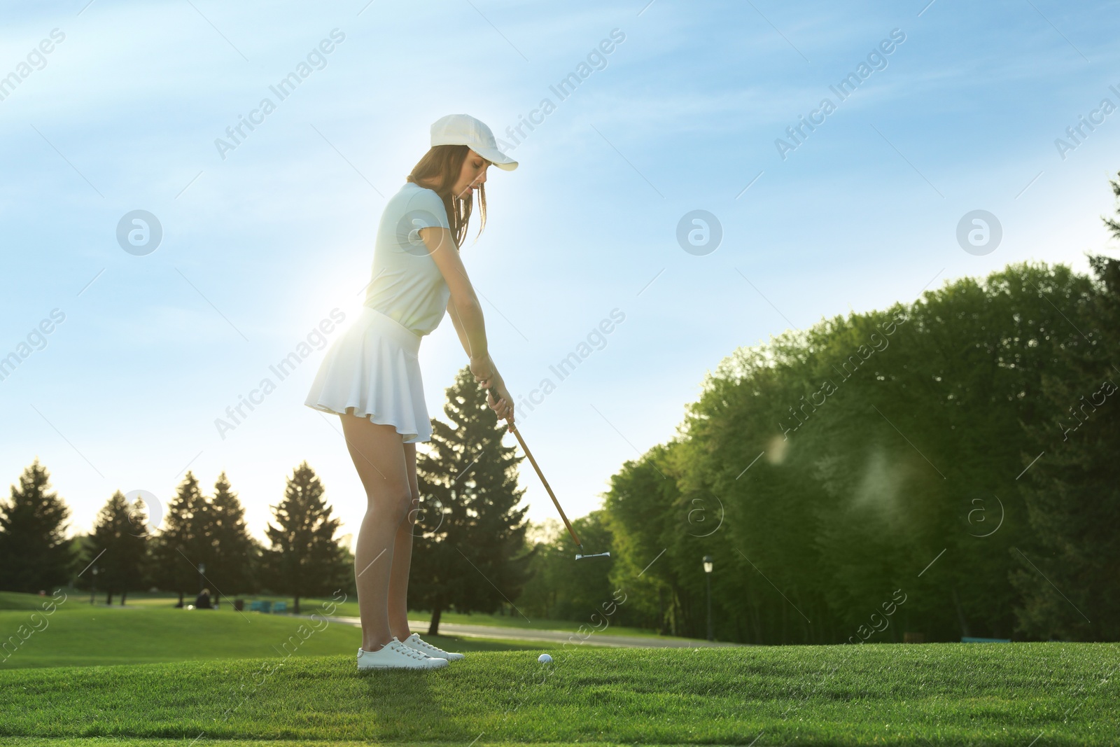 Photo of Beautiful woman playing golf on green course, space for text