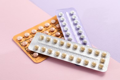 Photo of Blisters of contraceptive pills on color background, closeup