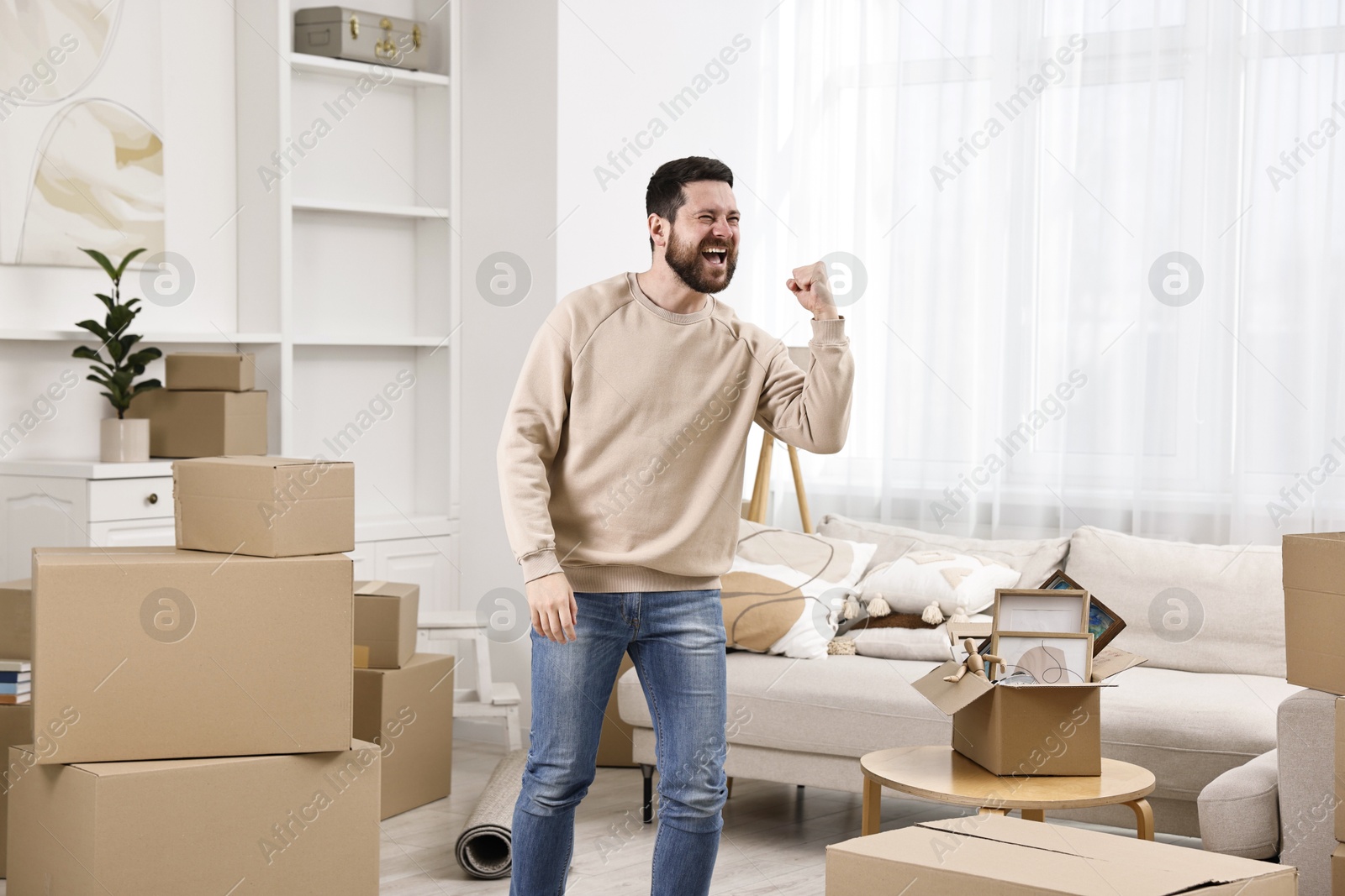 Photo of Moving day. Emotional man in his new home