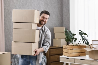 Moving day. Man with cardboard boxes in his new home