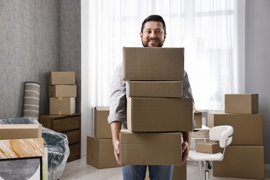 Moving day. Man with cardboard boxes in his new home