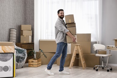 Moving day. Man with cardboard boxes in his new home