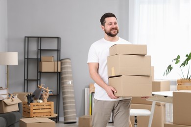 Moving day. Man with cardboard boxes in his new home