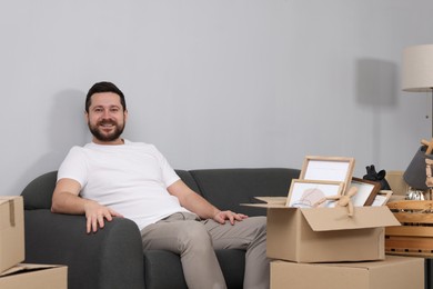 Moving day. Man with his belongings in new home