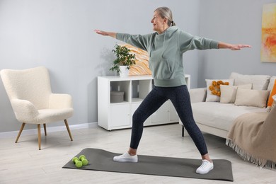 Smiling elderly woman doing exercise at home