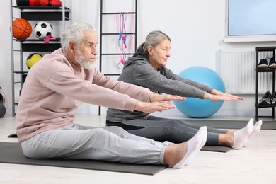 Elderly couple exercising at home. Healthy leisure