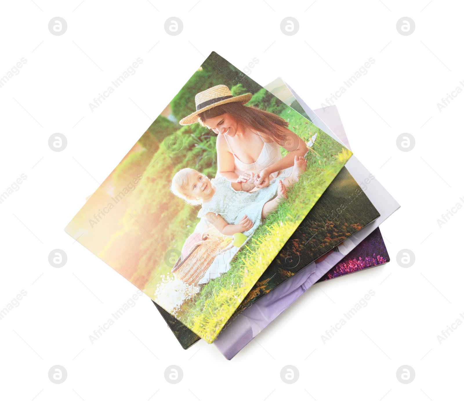 Photo of Canvas with different printed photos isolated on white, top view