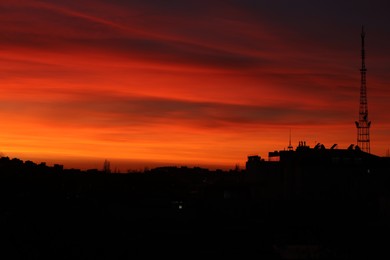 Picturesque view of city under beautiful sky at sunset